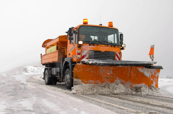 A big dump truck removing snow on the road