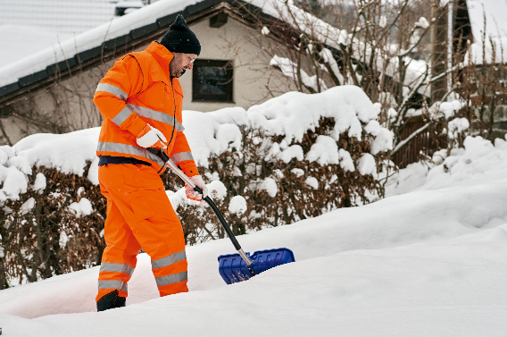 Man shoveling snow in Kitchener after snowfall